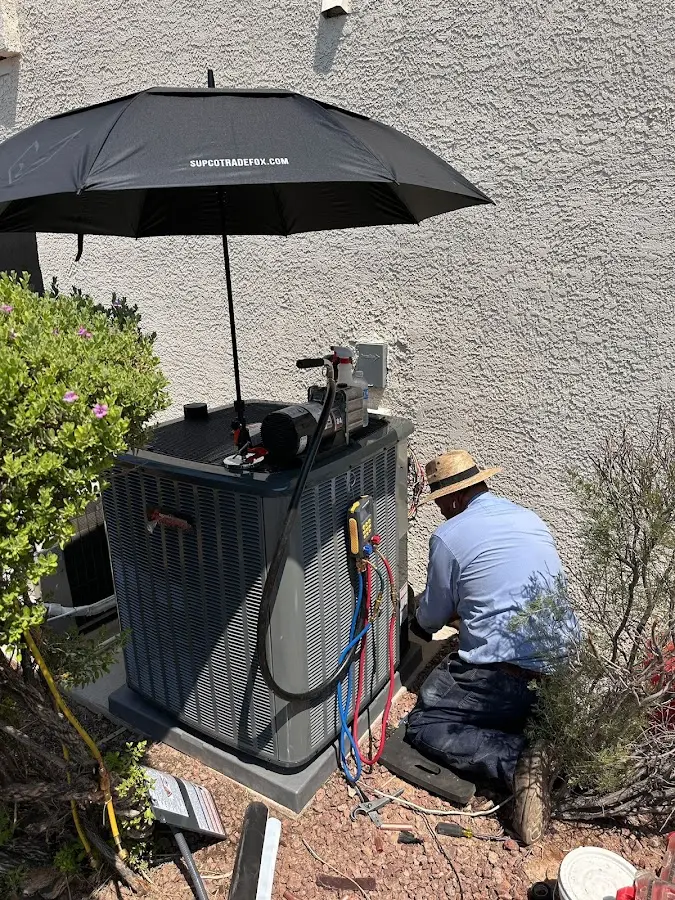 HVAC technician performing outdoor AC maintenance in Gypsum
